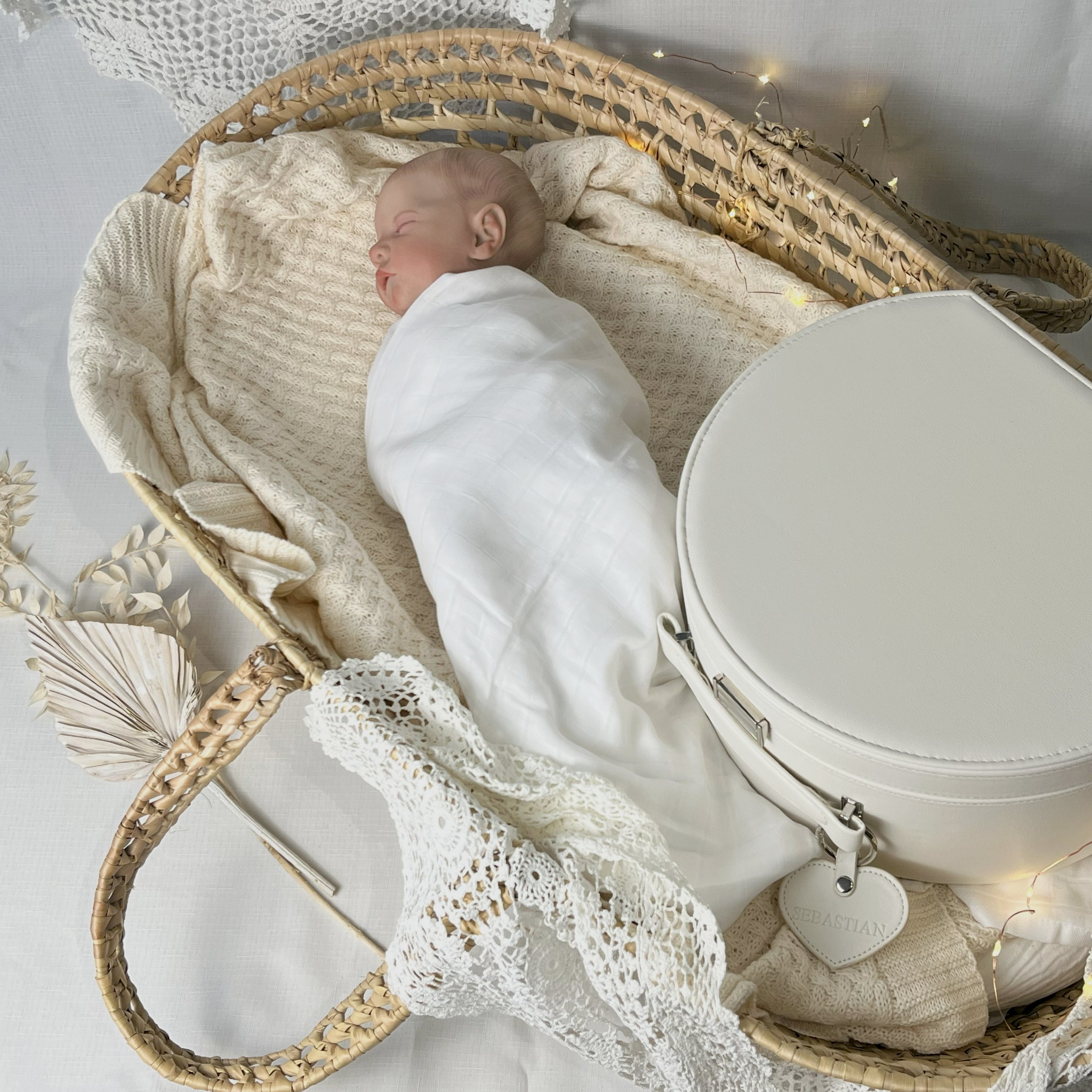 newborn baby in Moses basket with cream keepsake box