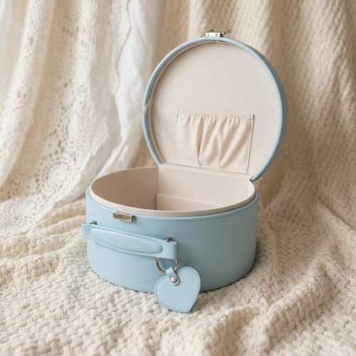 blue keepsake box with heart-shaped tag on a beige knitted baby blanket
