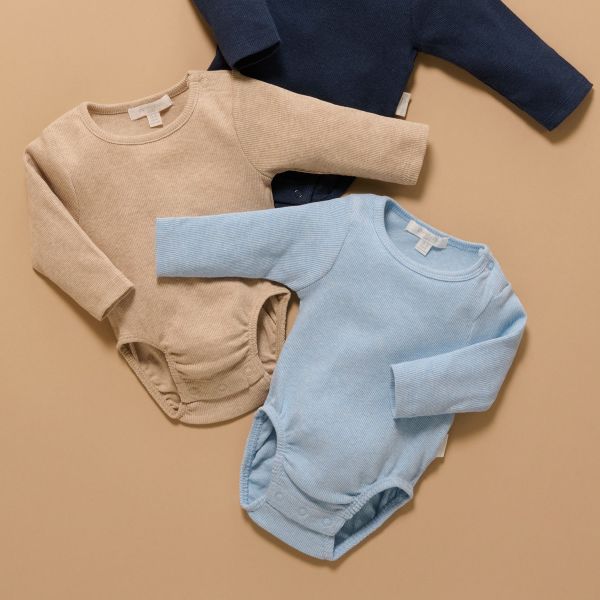 Beige and blue baby rompers on a beige background