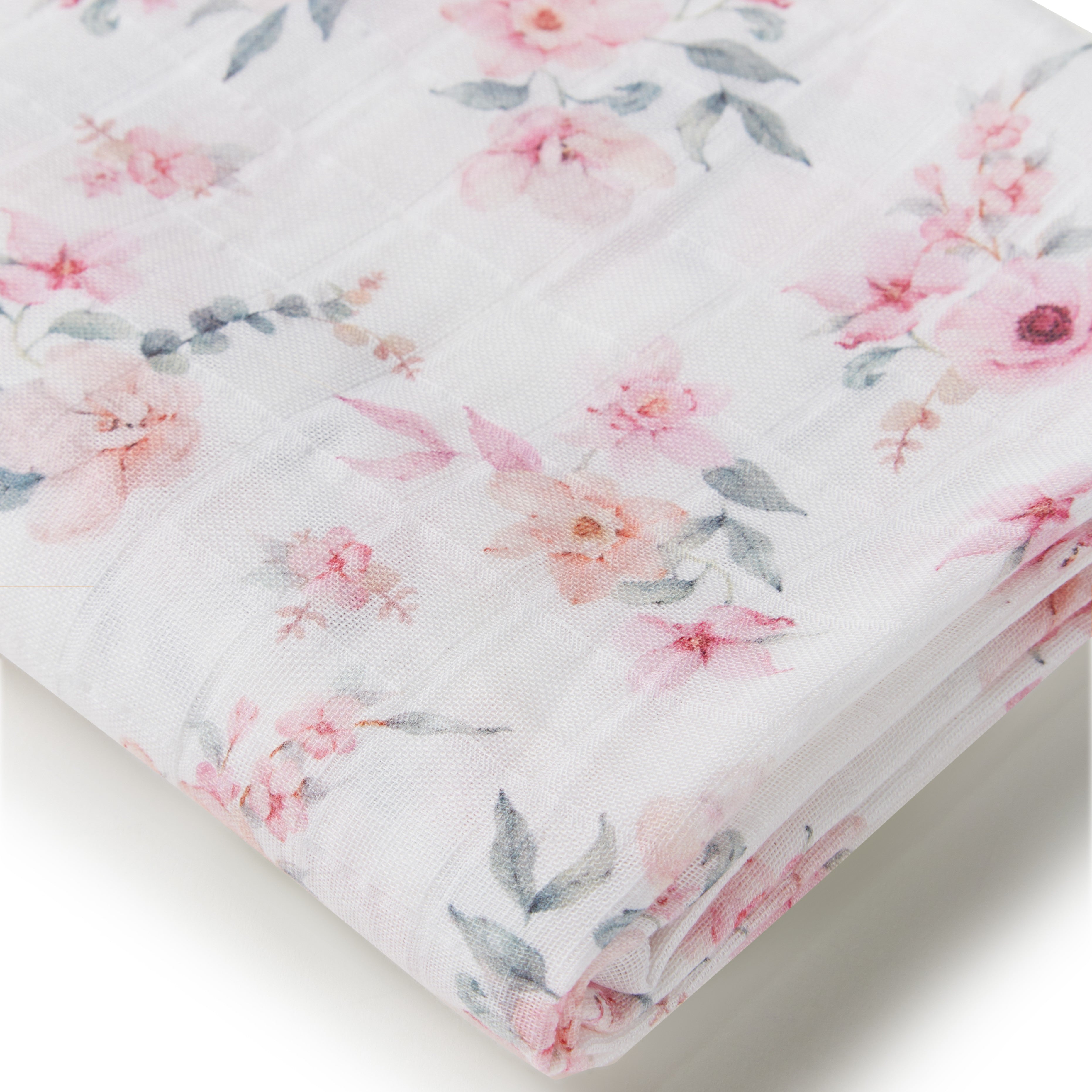 Floral patterned fabric with pink flowers and green leaves on a white background