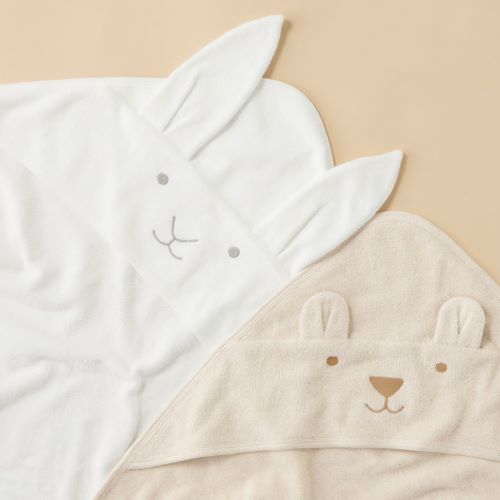 vanilla bunny hooded towel next to caramel bear hooded towel flat lay