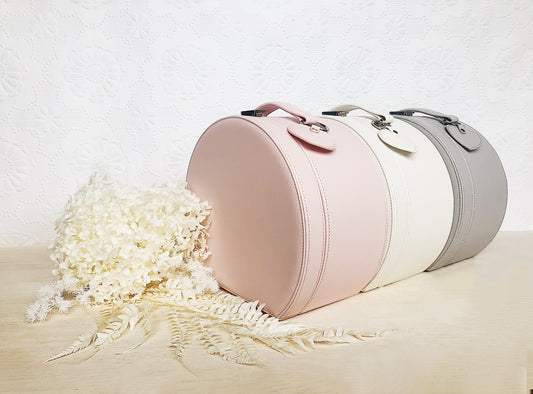 baby keepsake boxes lined up with white flowers surrounding