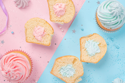 pink iced cupcake and blue iced cupcakes on pink and blue background