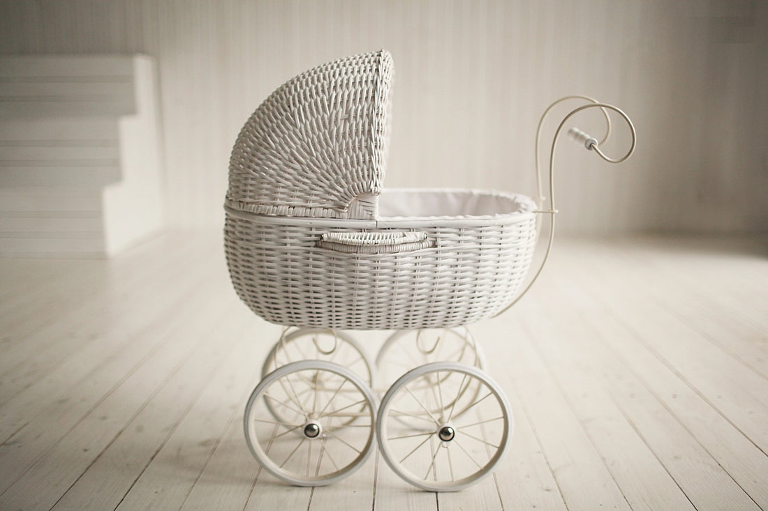 white vintage pram on timber floorboards