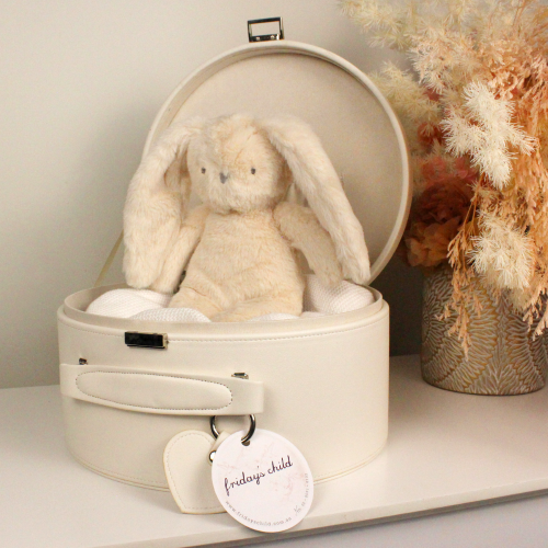 cream keepsake box open with an ivory plush bunny sitting inside with dried flower arrangement next to