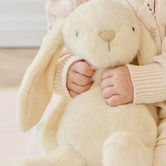 cream plush bunny in childs hands