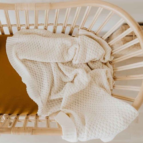 cream cotton blanket in timber baby cot