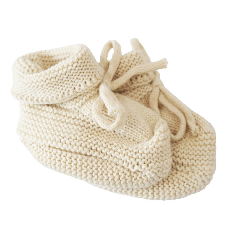 Knitted baby bootie on a white background