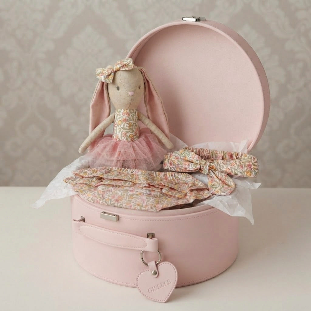 pink keepsake box with toy ballerina bunny, nappy cover and headband in lily pink print with neutral background