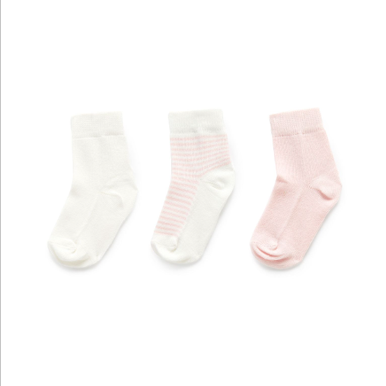 Three pairs of baby socks in white and pink on a white background