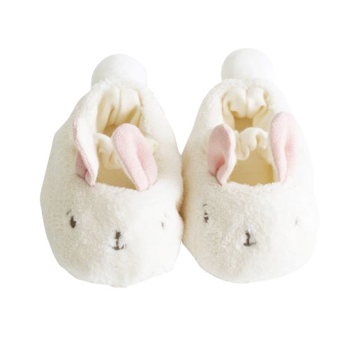 pair of fluffy bunny slippers with pink ears on white background