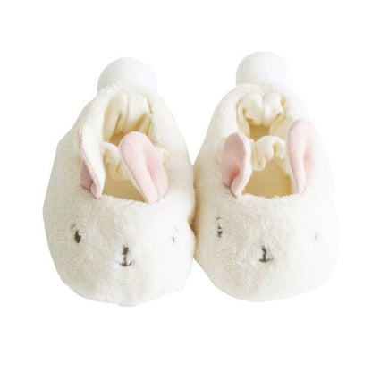 pair of fluffy bunny slippers with pink ears on white background