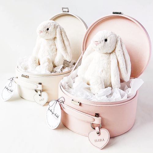 two keepsake boxes side by side, one pink and one cream, both with cream bunnies sitting inside