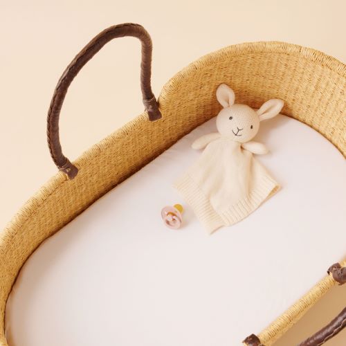 knitted bunny comforter in a cane Moses basket