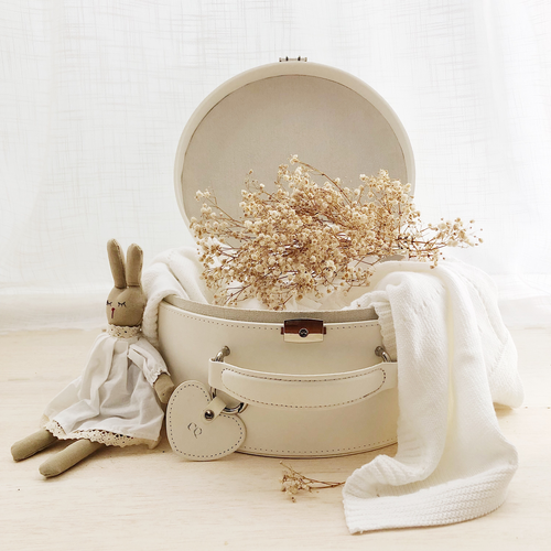 cream keepsake box decorated with dried flowers and a toy bunny sitting next to the box