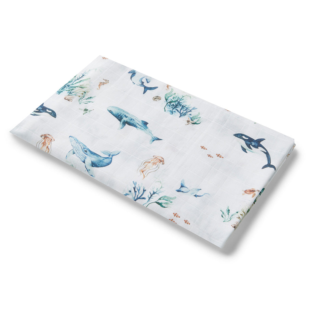 Muslin fabric with coral and whale pattern on a white background