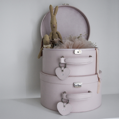 two pink keepsake boxes stacked on top of each other. The top box is open with two bunny toys shown inside
